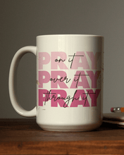 Load image into Gallery viewer, 15oz Pray on it mug sitting on a dark table
